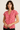 Woman wearing a red and white patterned blouse against a beige background
