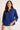 Woman wearing a blue shirt against a beige background