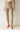 Person wearing beige pants and a white top 