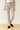 Person wearing light gray jeans and black shoes 