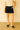 Person wearing H&M 100% cotton black shorts and black sandals 