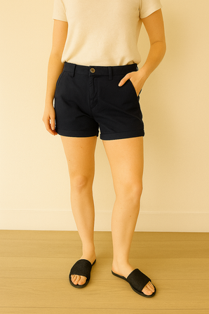 Person wearing H&M 100% cotton black shorts and black sandals 