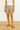 Person wearing Mango beige shorts and white top and beige flats