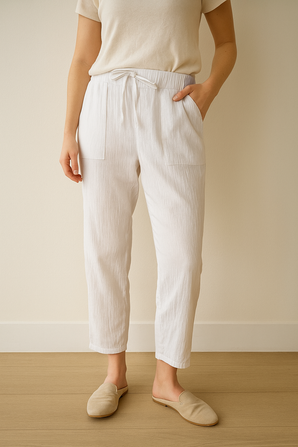 Person wearing white M&S - Per Una pants and a beige top and beige flats