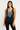Woman wearing a black tank top with decorative elements on a white background