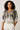 Woman wearing a patterned blouse with a plain background