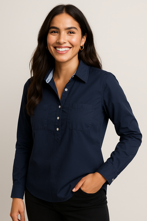 Woman wearing a navy blue shirt against a plain background