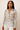 Woman wearing a floral blouse with a plain background