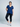 Woman wearing a blue top and black leggings on a white background