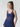 Woman wearing a blue tank top against a plain background