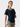 Woman wearing a navy blue top and green shorts on a white background